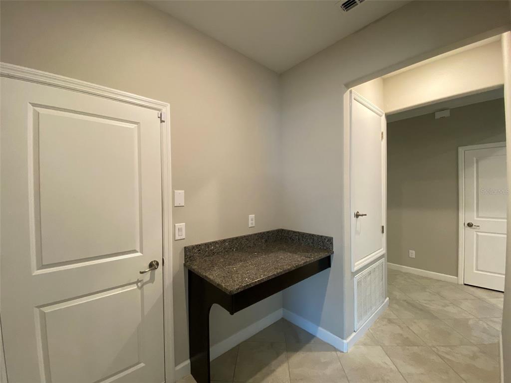 10049 Victory Gallop Loop Ruskin, FL 33573 - Photo 5 of 22 a view of kitchen cabinets and wooden floor
