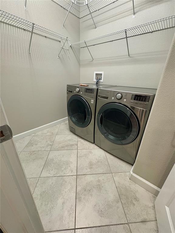 10049 Victory Gallop Loop Ruskin, FL 33573 - Photo 9 of 22 a utility room with dryer and washer
