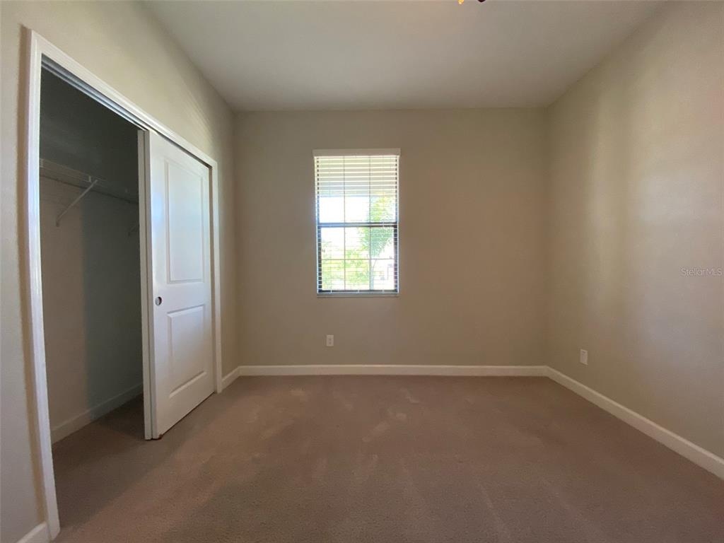 10049 Victory Gallop Loop Ruskin, FL 33573 - Photo 10 of 22 an empty room with windows