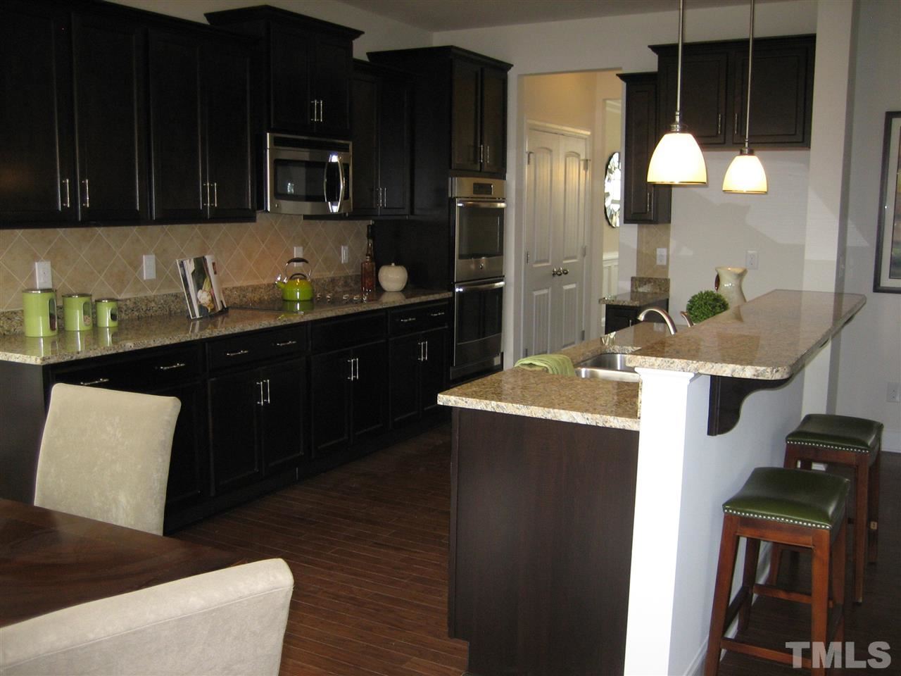 2445 Everstone Road Wake Forest, NC 27587 - Photo 6 of 22 Kitchen open to family room. Lots of cabinets / stainless appliances!