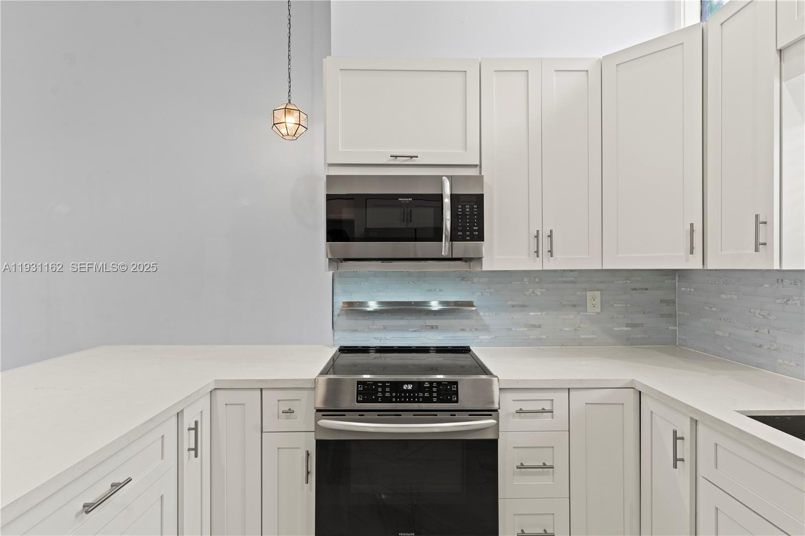 9301 Southwest 130th Street Miami, FL 33176 - Photo 11 of 32 a kitchen with granite countertop white cabinets and stainless steel appliances