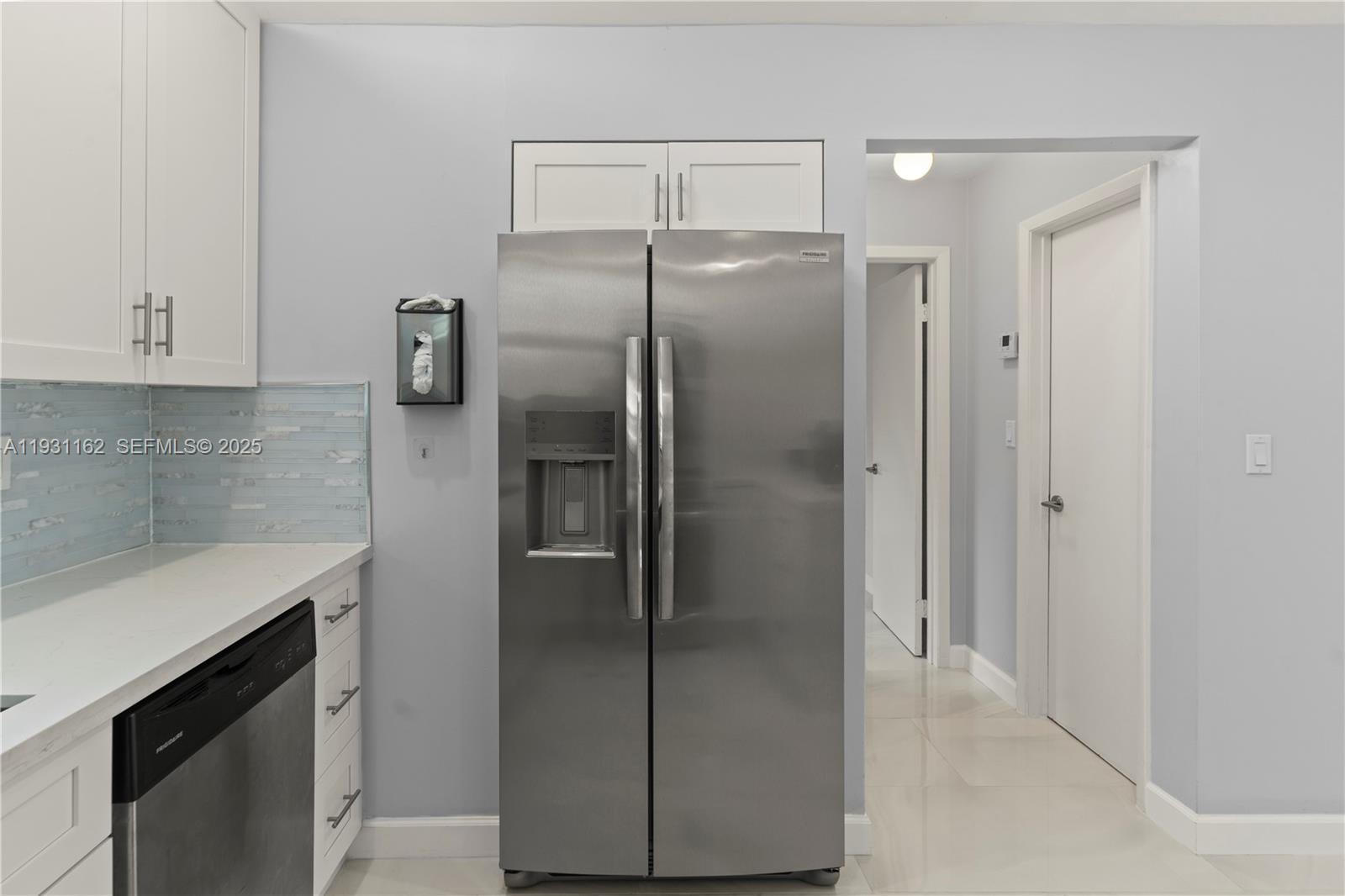 9301 Southwest 130th Street Miami, FL 33176 - Photo 12 of 32 a metallic refrigerator freezer sitting in a kitchen