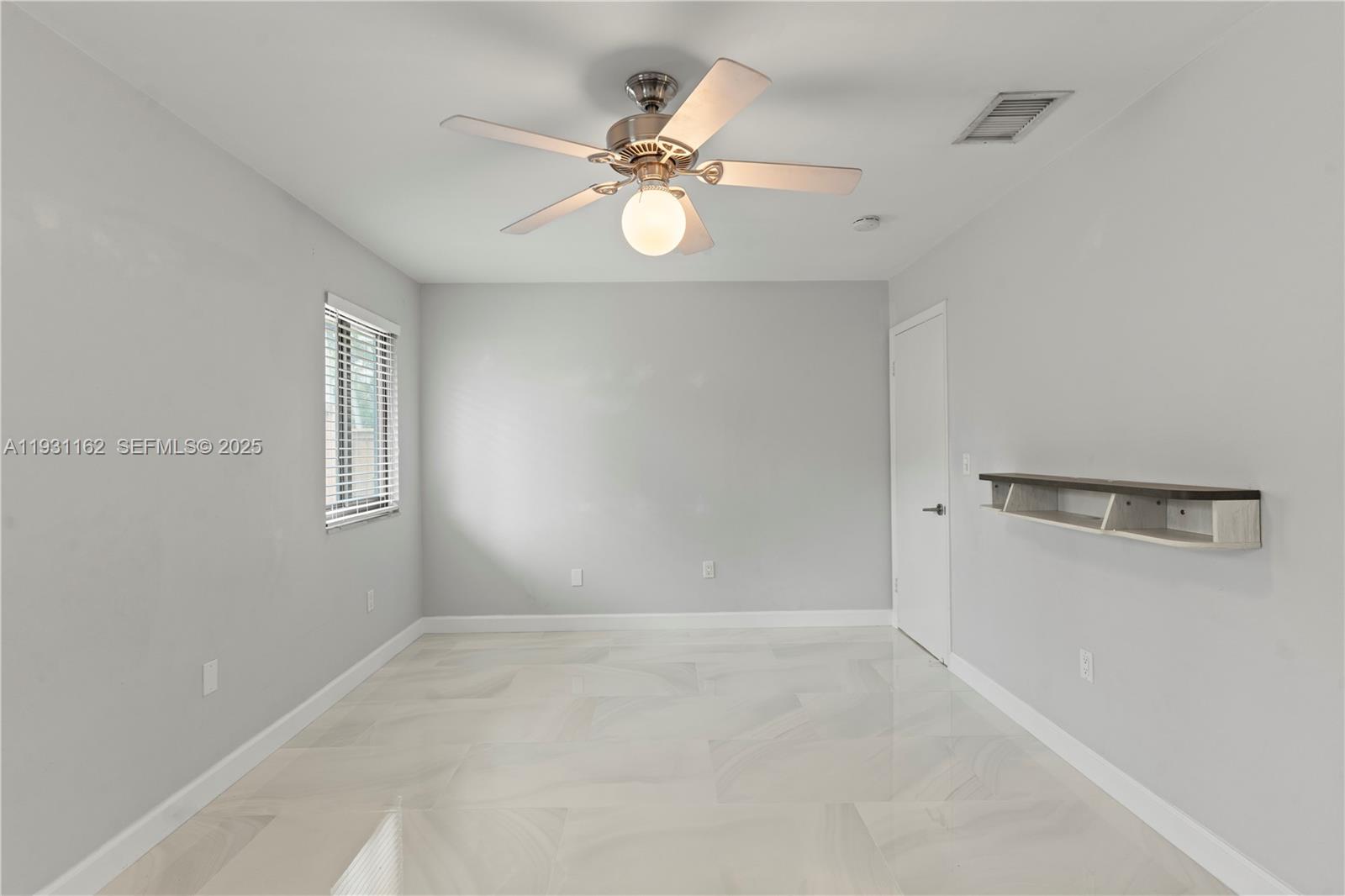 9301 Southwest 130th Street Miami, FL 33176 - Photo 18 of 32 a view of an empty room with a window
