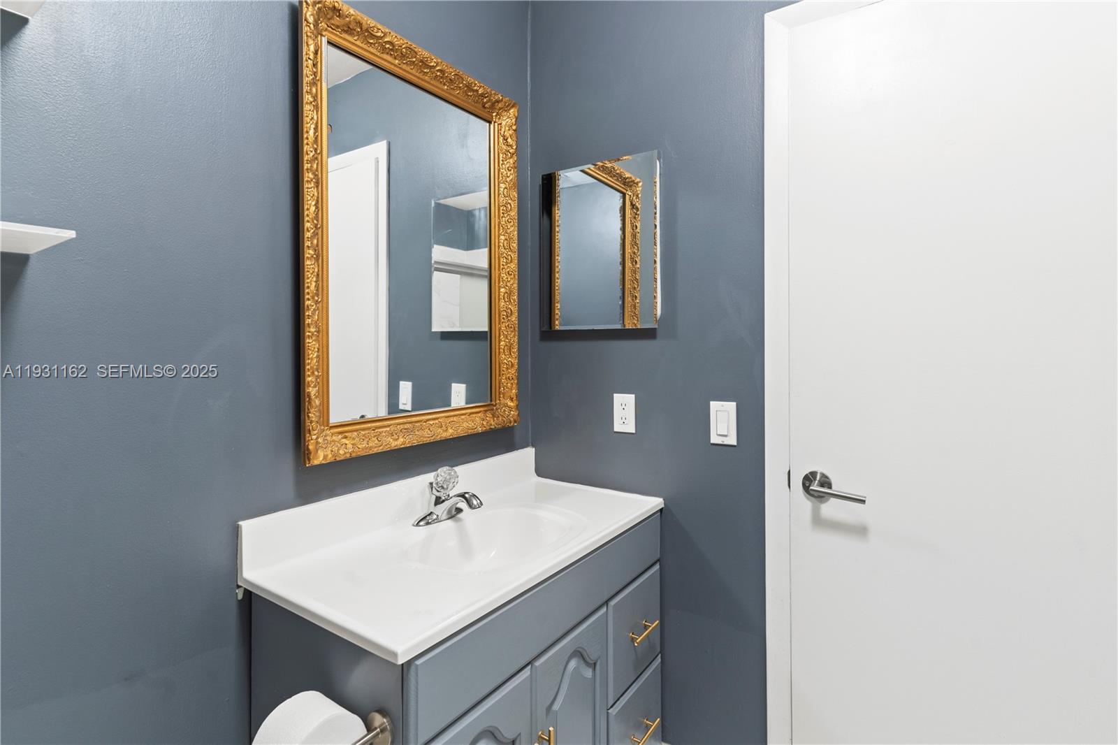 9301 Southwest 130th Street Miami, FL 33176 - Photo 23 of 32 a bathroom with a sink and a mirror