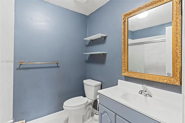a bathroom with a sink a toilet and mirror