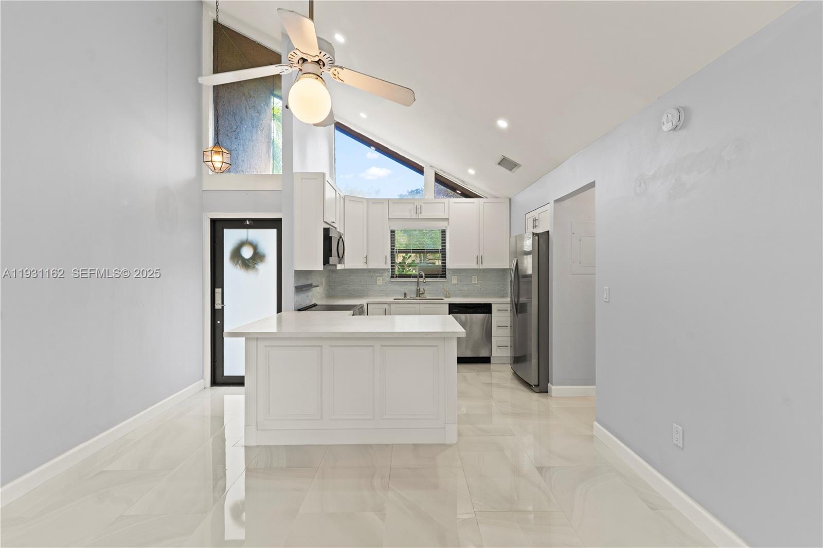 9301 Southwest 130th Street Miami, FL 33176 - Photo 5 of 32 a kitchen with a sink and a stove top oven