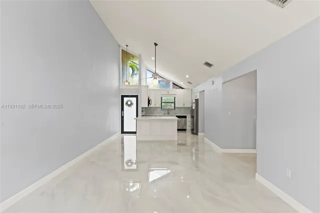 a view of kitchen with furniture and refrigerator
