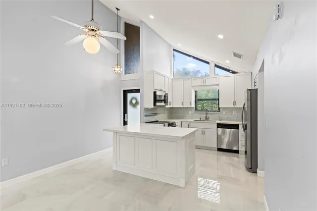 a kitchen with cabinets and stainless steel appliances