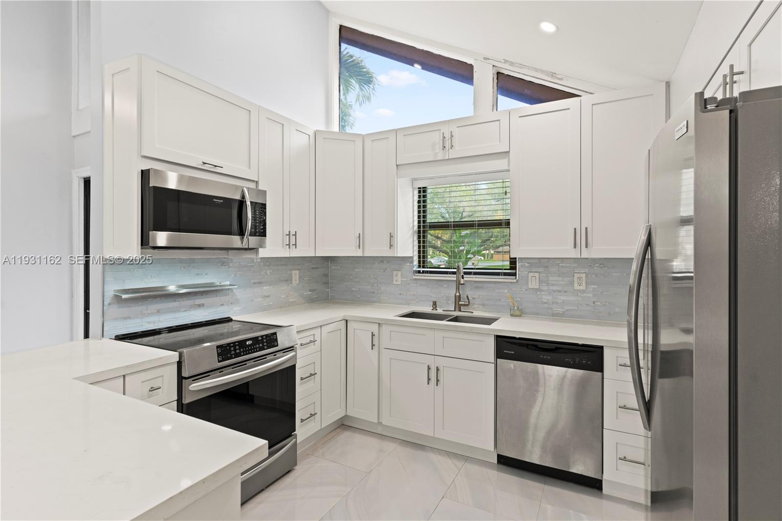 9301 Southwest 130th Street Miami, FL 33176 - Photo 10 of 32 a kitchen with a sink stove and microwave
