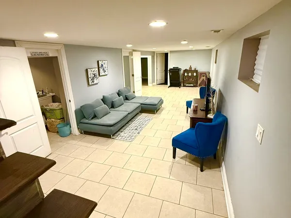a living room with furniture and a flat screen tv