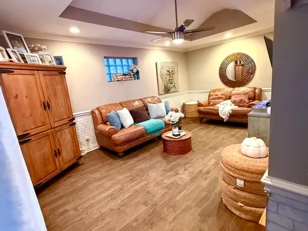 a living room with furniture a rug and a mirror