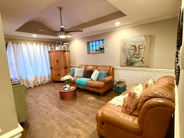 a living room with furniture and a chandelier