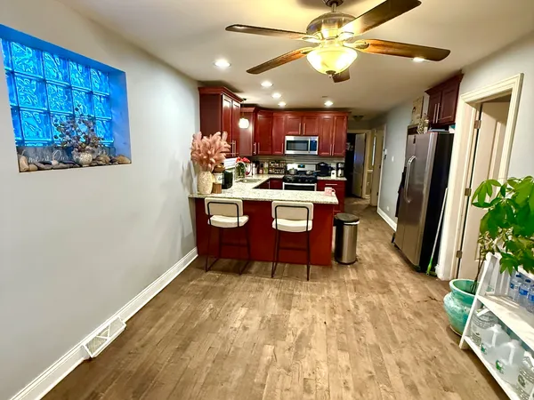 a view of a kitchen with furniture and a ceiling fan