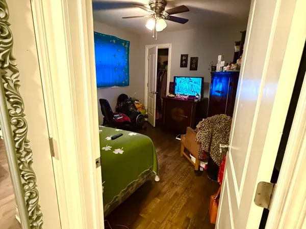 a bedroom with a bed and a chandelier