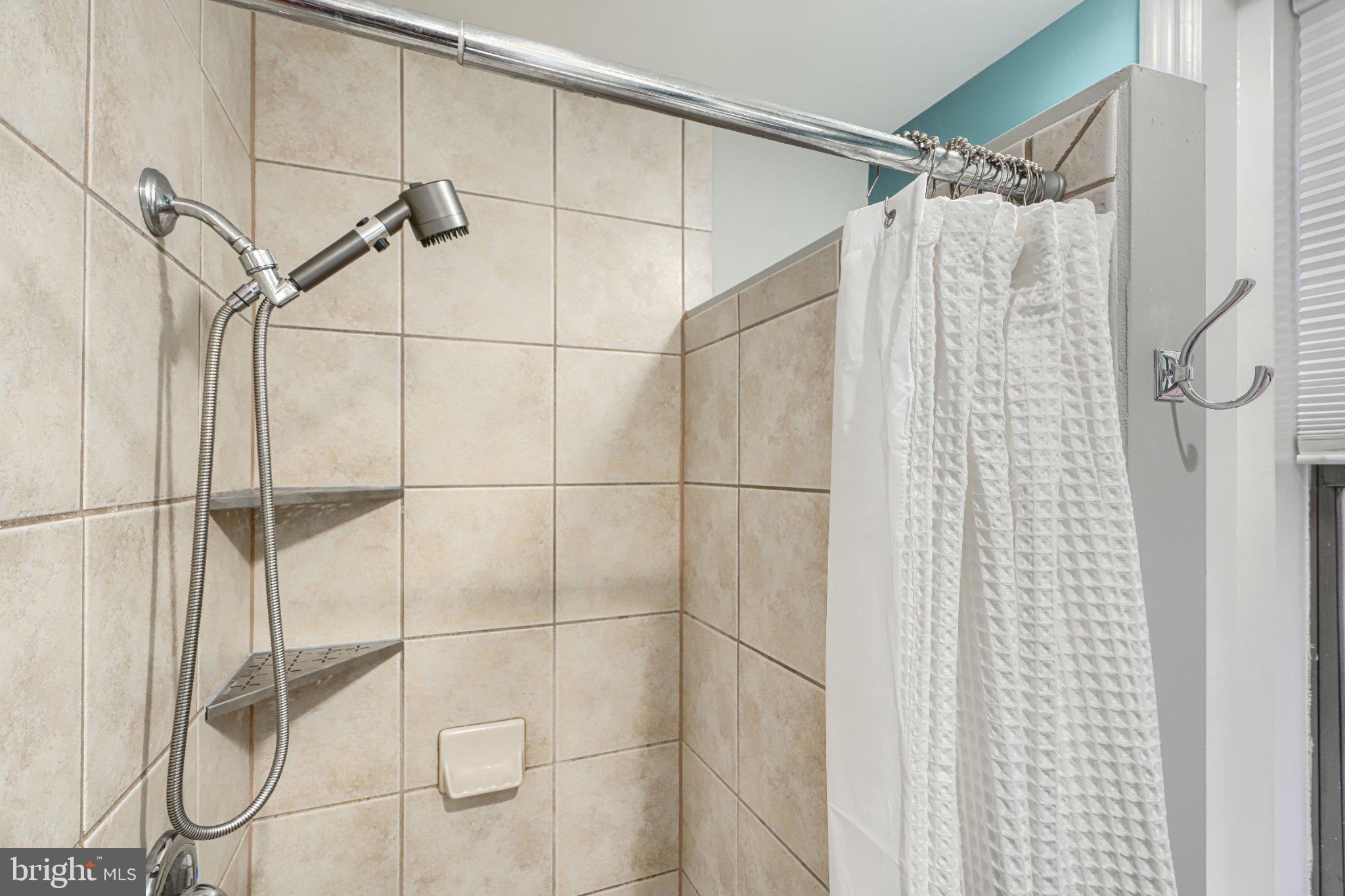 1018 North Charles Street, Unit R Baltimore, MD 21201 - Photo 12 of 17 Modern shower with sleek tiles.