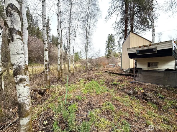 a backyard of a house with table and chairs