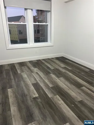 a view of a closet area with wooden floor