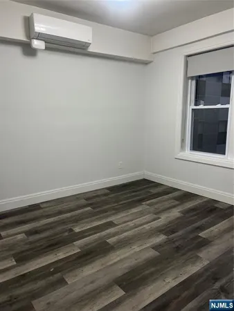 a view of a room with wooden floor and a window