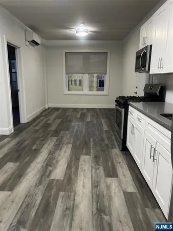 a kitchen with granite countertop a stove and a refrigerator