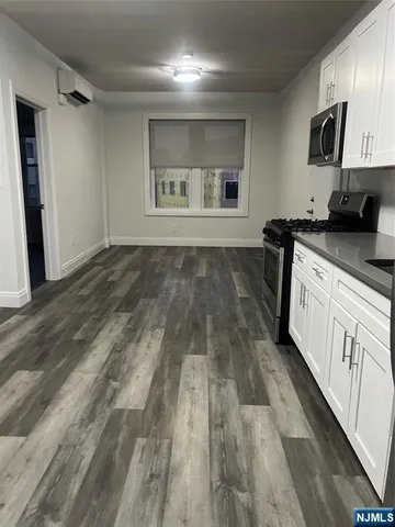 a kitchen with granite countertop a stove and a refrigerator