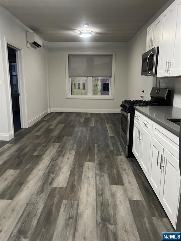 104 Park Avenue Rutherford, NJ 07070 - Photo 4 of 12 a kitchen with granite countertop a stove and a refrigerator