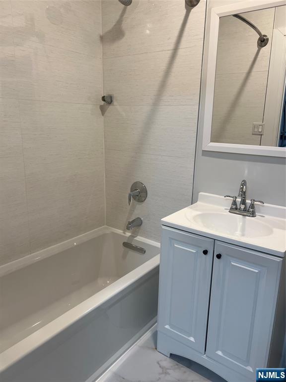 104 Park Avenue Rutherford, NJ 07070 - Photo 5 of 12 a bathroom with a bathtub sink vanity and mirror