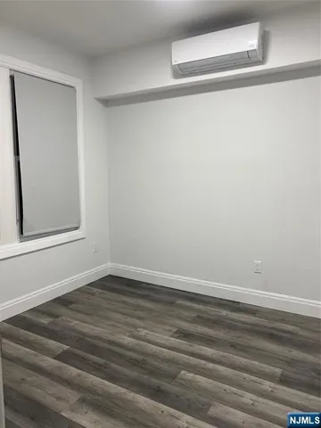 a view of a small space with wooden floor and closet