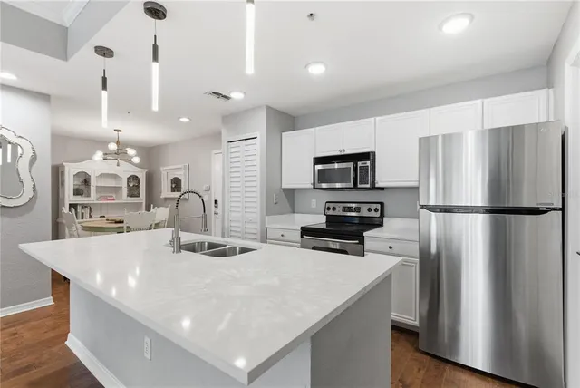 a kitchen with stainless steel appliances a refrigerator and a stove