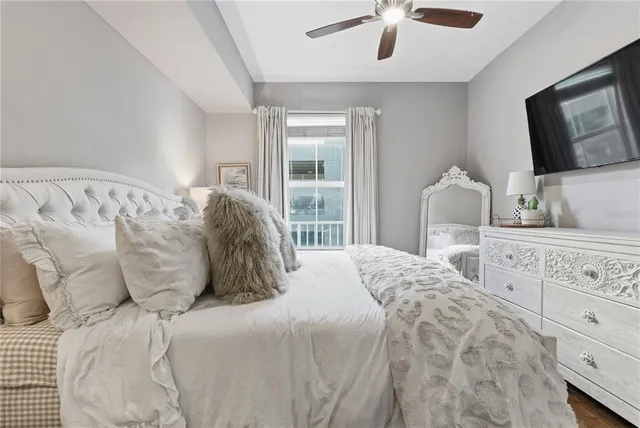 a bedroom with a bed and a flat tv screen on dresser