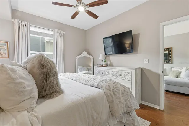 a bedroom with a bed and a flat screen tv