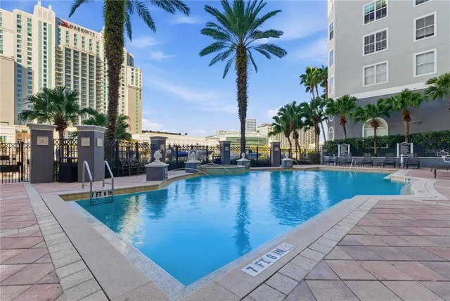 a view of swimming pool with outdoor seating and plants