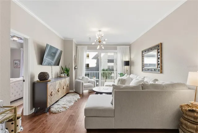 a living room with furniture and a chandelier