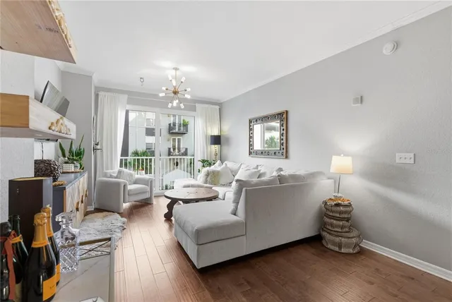 a living room with furniture and a chandelier