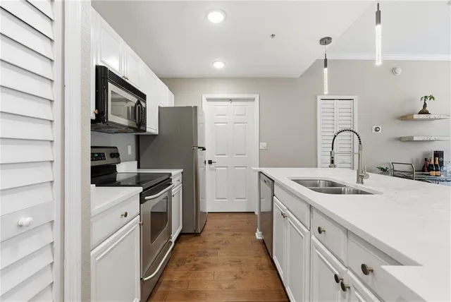 a kitchen with a sink stove and refrigerator