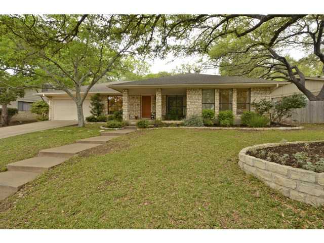 2300 Cypress Point East Austin, TX 78746 - Photo 1 of 1 a front view of a house with a garden and yard