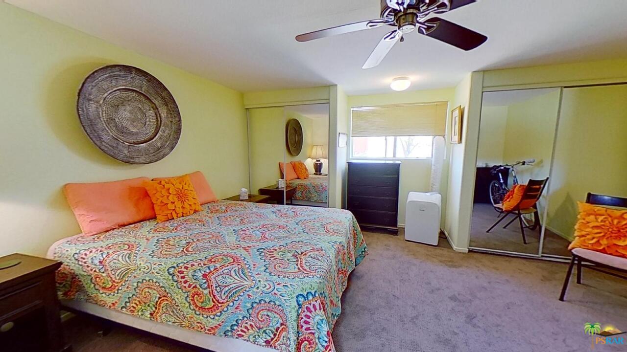 61612 Sagebrush Road North Palm Springs, CA 92258 - Photo 12 of 30 a bedroom with a bed and a chandelier