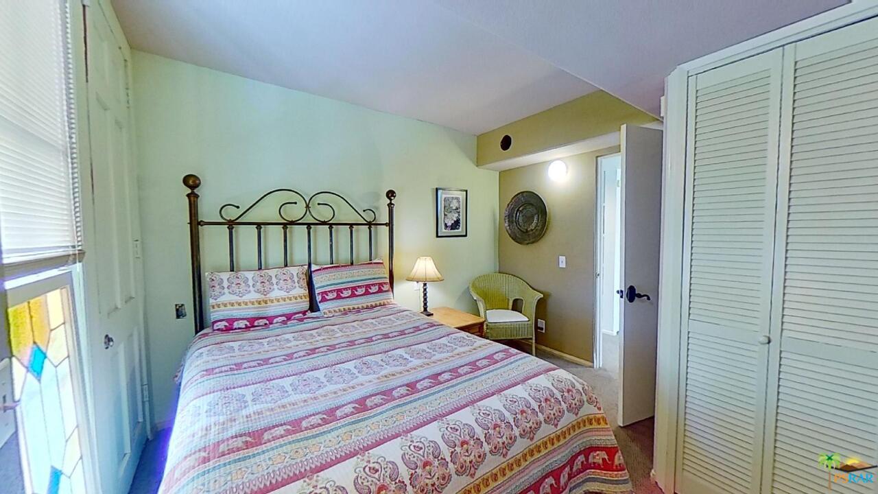 61612 Sagebrush Road North Palm Springs, CA 92258 - Photo 14 of 30 a bedroom with a bed and a painting on the wall