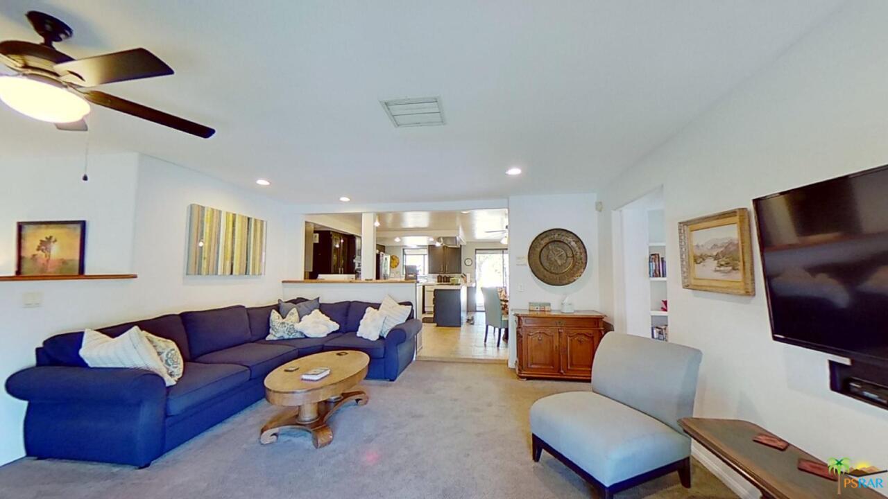 61612 Sagebrush Road North Palm Springs, CA 92258 - Photo 4 of 30 a living room with furniture a air conditioner and a flat screen tv