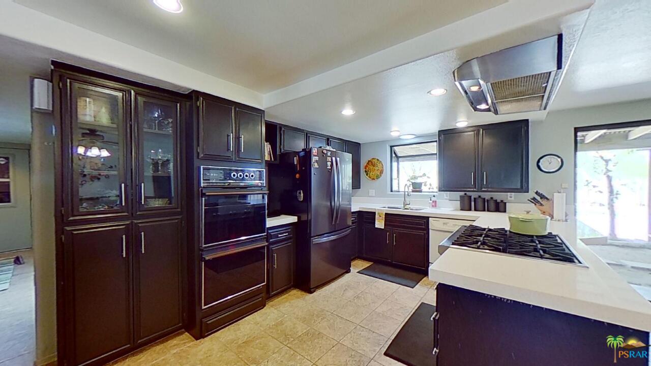 61612 Sagebrush Road North Palm Springs, CA 92258 - Photo 6 of 30 a kitchen with a refrigerator stove and sink