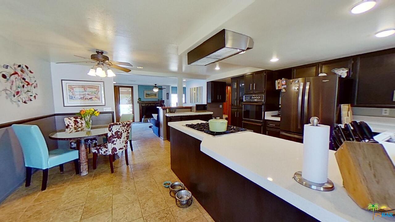 61612 Sagebrush Road North Palm Springs, CA 92258 - Photo 8 of 30 a living room with stainless steel appliances lots of furniture and kitchen view