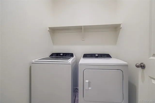 a view of a house with wooden fence