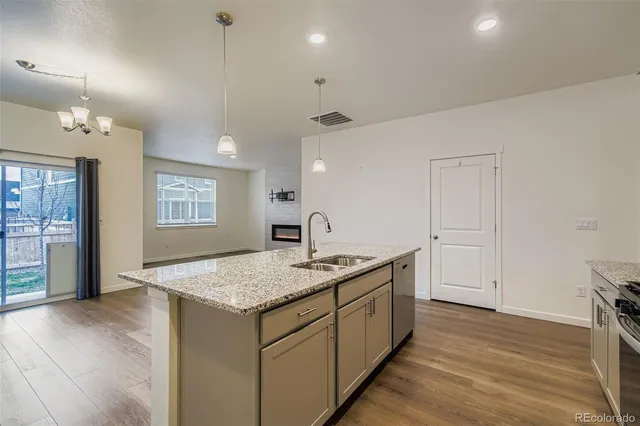 a hall with kitchen island white cabinets and sink