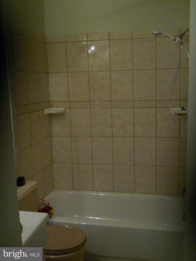 4412 Havelock Road Lanham, MD 20706 - Photo 3 of 11 a bathroom with a shower and a bathtub