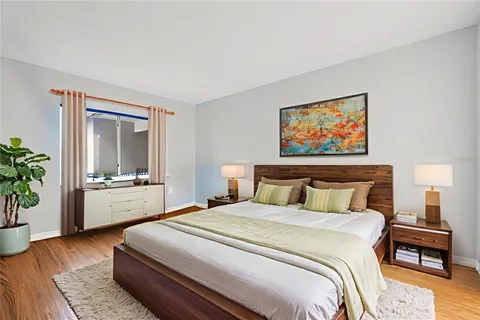 a bedroom with a bed and a large window