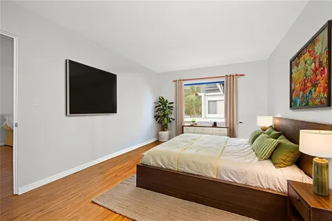 a bedroom with a bed and a flat screen tv
