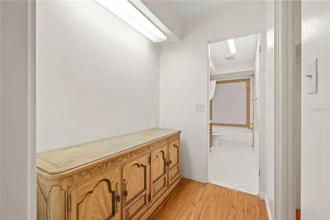 a view of a hallway with wooden floor