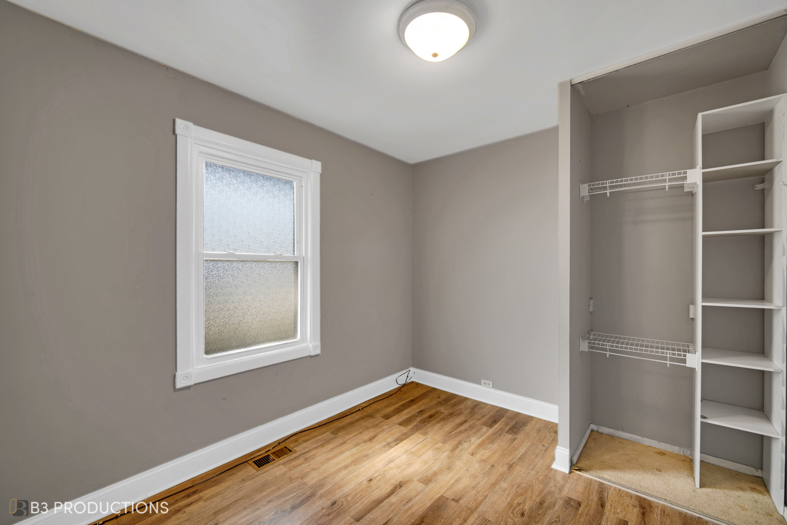 22 Arlington Drive Romeoville, IL 60446 - Photo 13 of 15 a view of empty room with wooden floor and fan