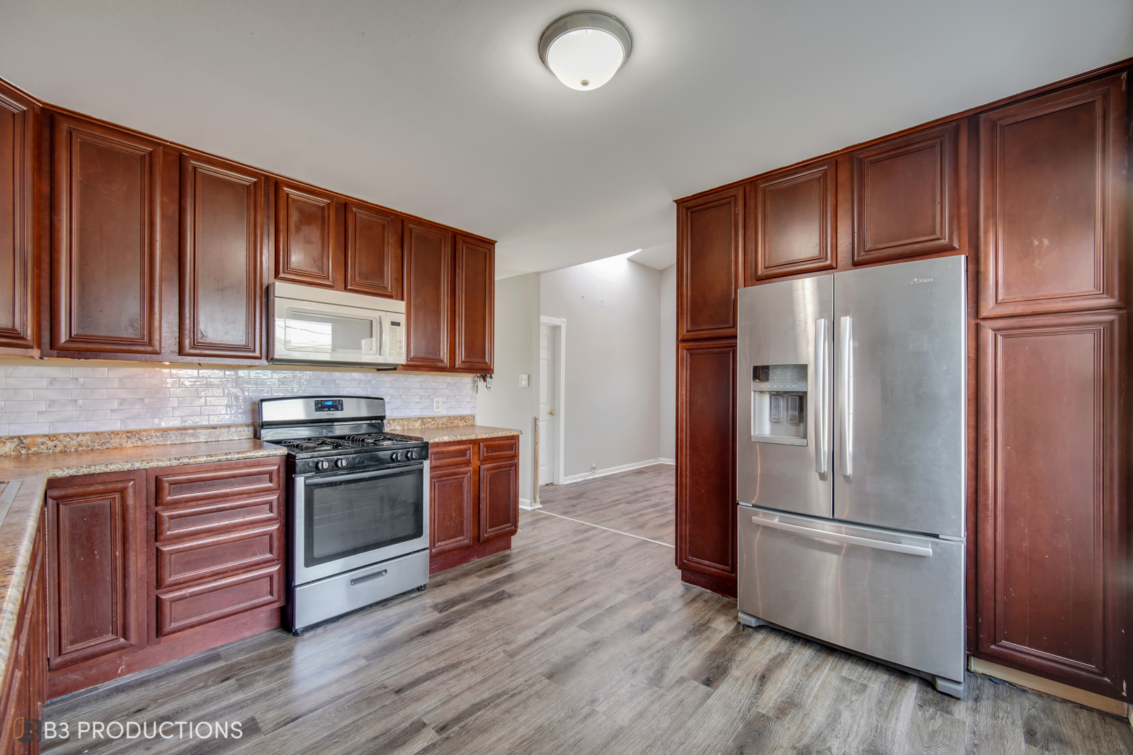 22 Arlington Drive Romeoville, IL 60446 - Photo 3 of 15 a kitchen with stainless steel appliances granite countertop a refrigerator stove and sink