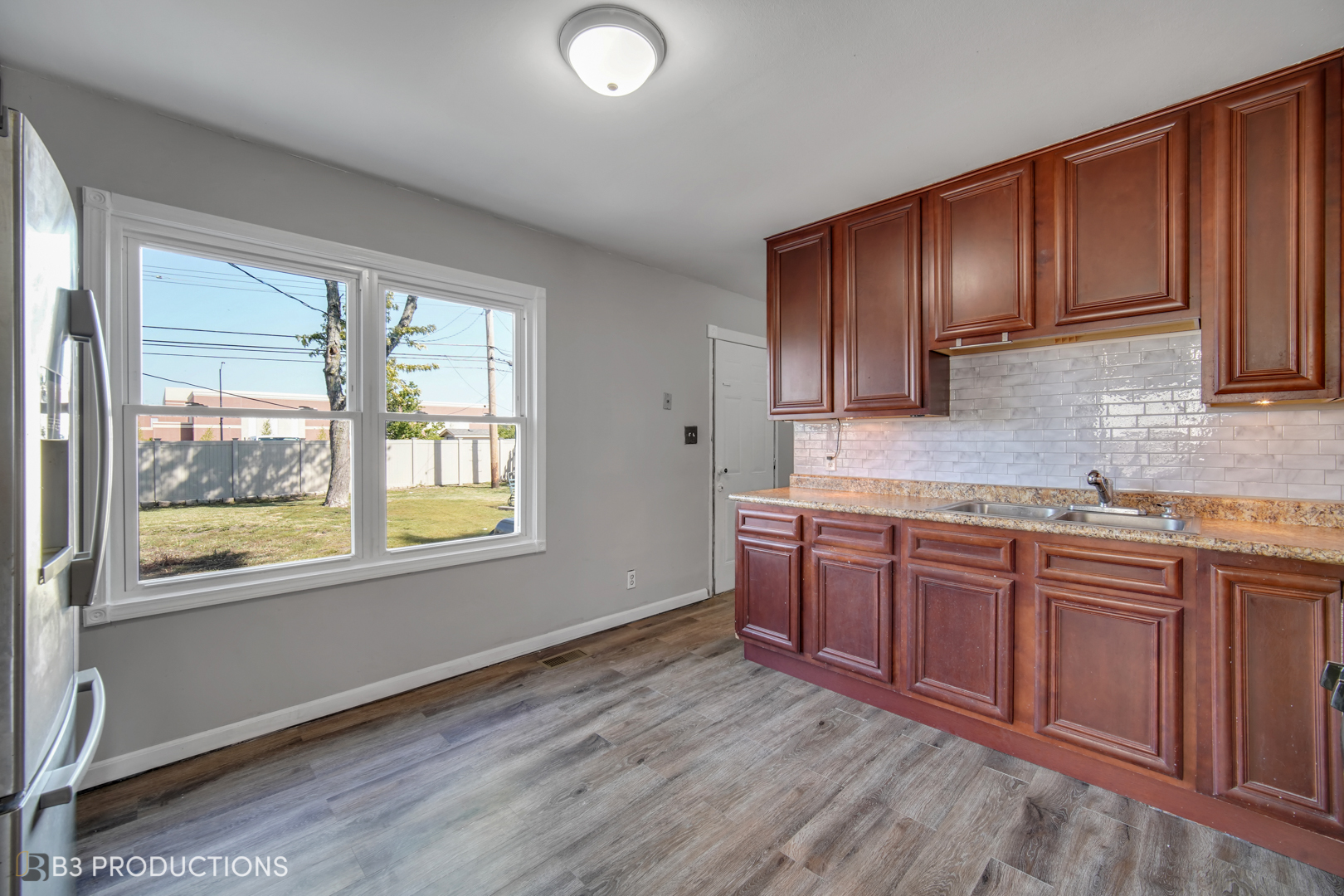 22 Arlington Drive Romeoville, IL 60446 - Photo 4 of 15 a kitchen with stainless steel appliances granite countertop wooden cabinets a sink and dishwasher with wooden floor