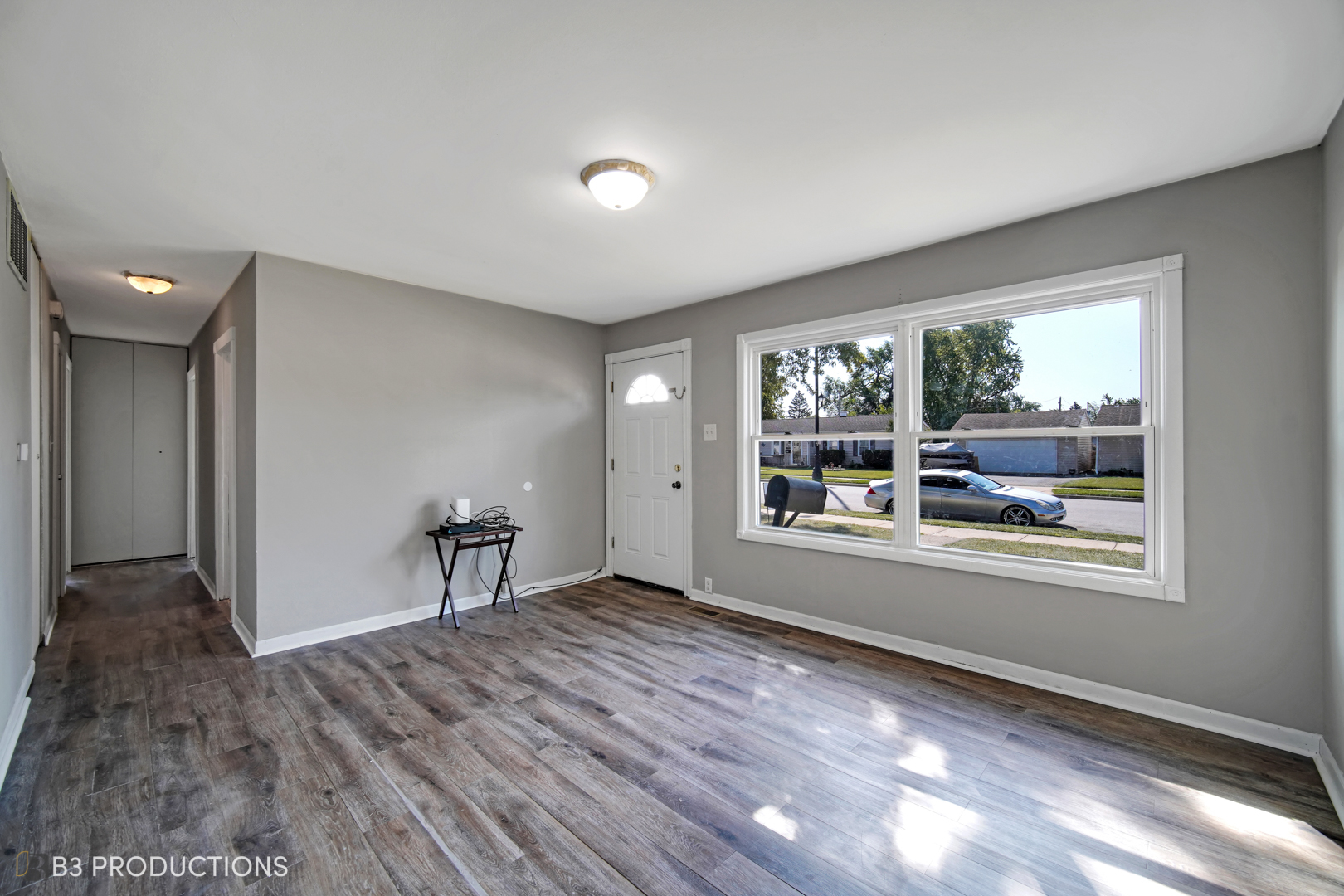 22 Arlington Drive Romeoville, IL 60446 - Photo 7 of 15 a view of an empty room with a window and wooden floor